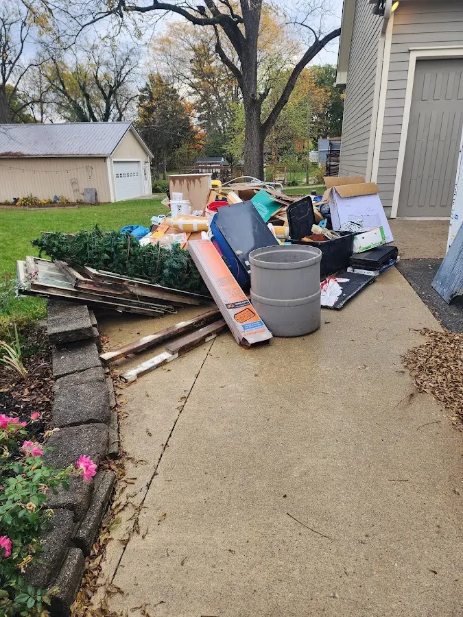 Dumpster being loaded with debris for 12 Yard Dumpster Rental in Highlands Ranch